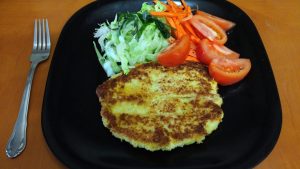 Dish of Chicken cutlet called Katsu served with salad.