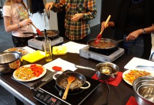 Students make the stir-fried noodle dish, japchae.