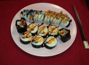 California Roll together with Korean Kimbab roll made with rice, seaweed sheets and other ingredients.
