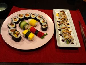Assortment of Sushi Rolls: Japanese California Roll, Korean Kimbap and Nigiri rice balls.